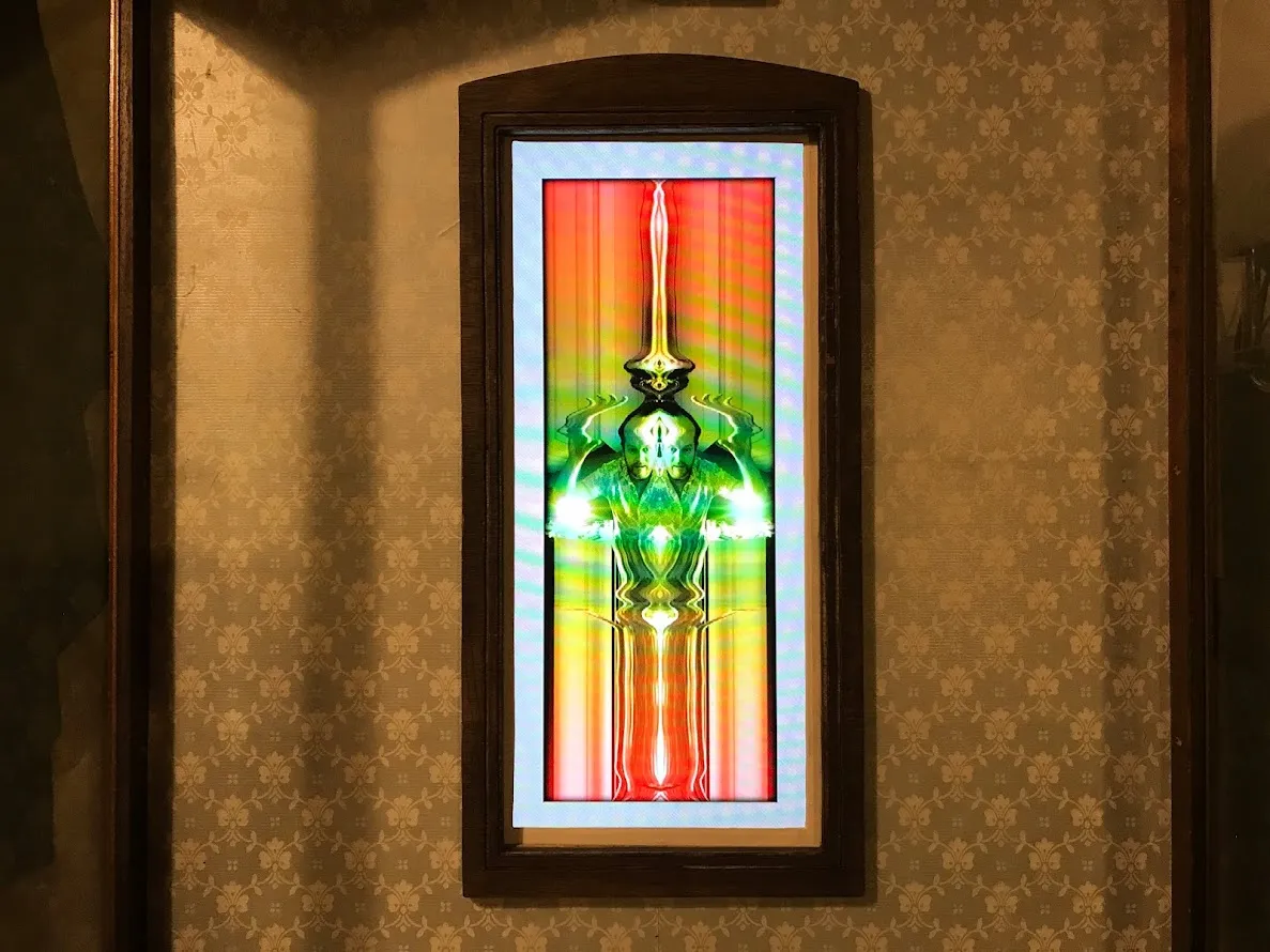 Man with pained expression in colourful screen altered
display.