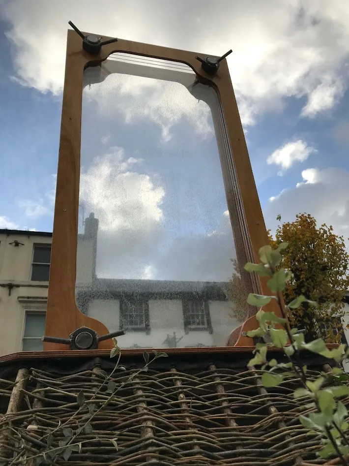 Looking through sculpture to a blue and cloud sky