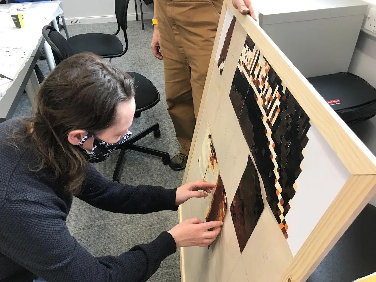 woman putting card on a board