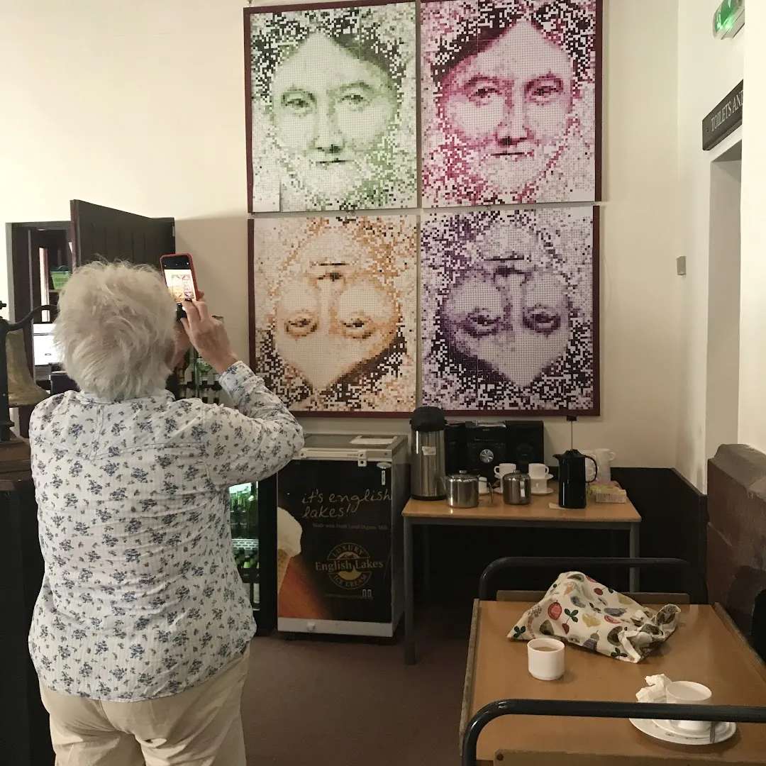 Woman taking photo of picture on the wall