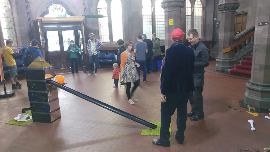 people milling around golf hole in room