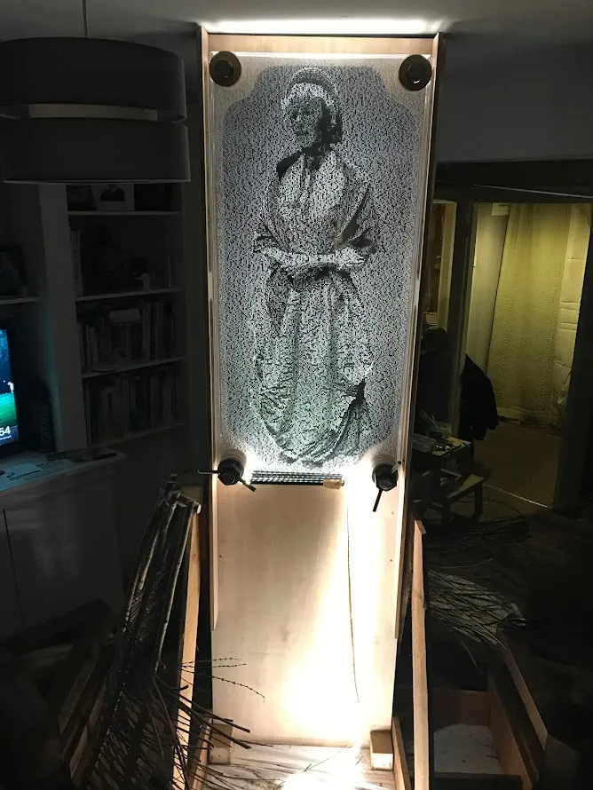 Light sculpture in lounge showing glowing woman made of letters
