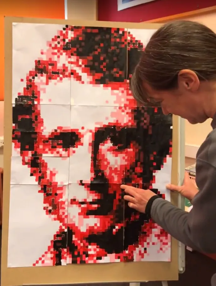 Woman adding sheet to portrait.