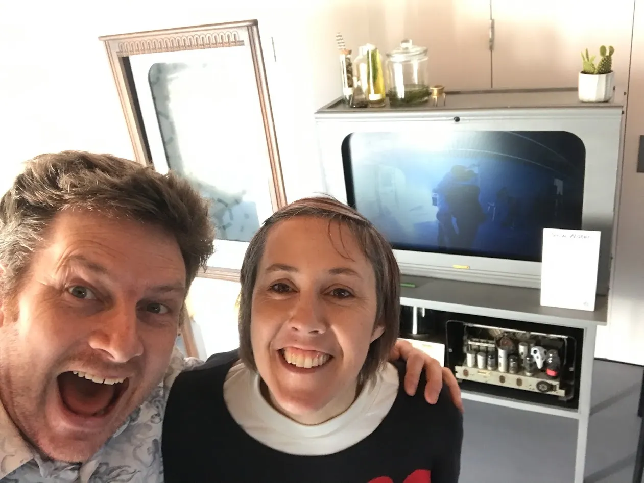 Chris and Jennie with screens behind