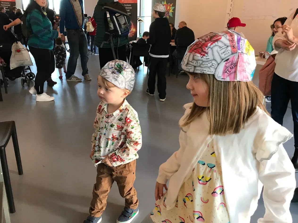Young boy and girl in cardboard hats