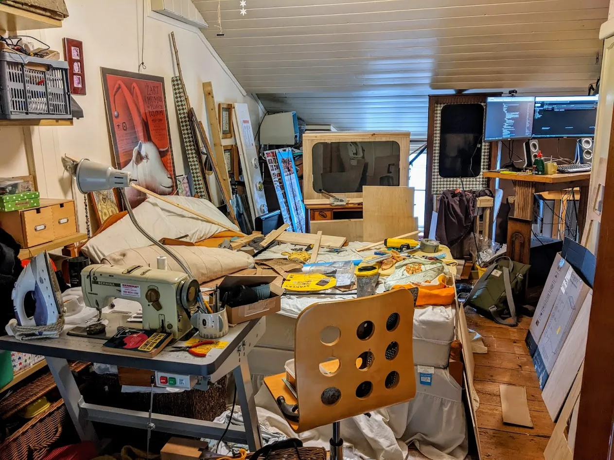 Incredibly messy room, tools and machines everywhere.