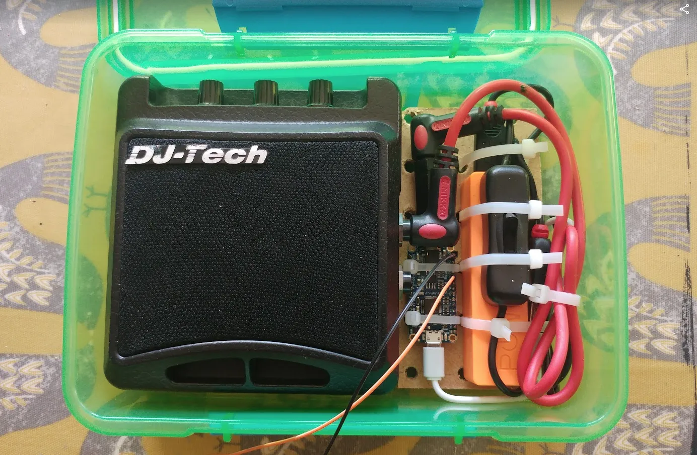 box with speaker, switch, circuit board and battery.