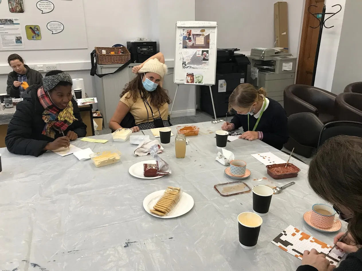People sitting around a table painting
