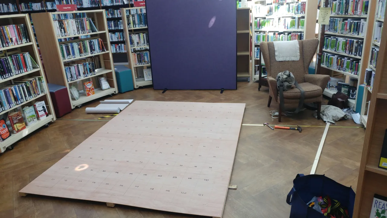 Full board lying on floor of library.