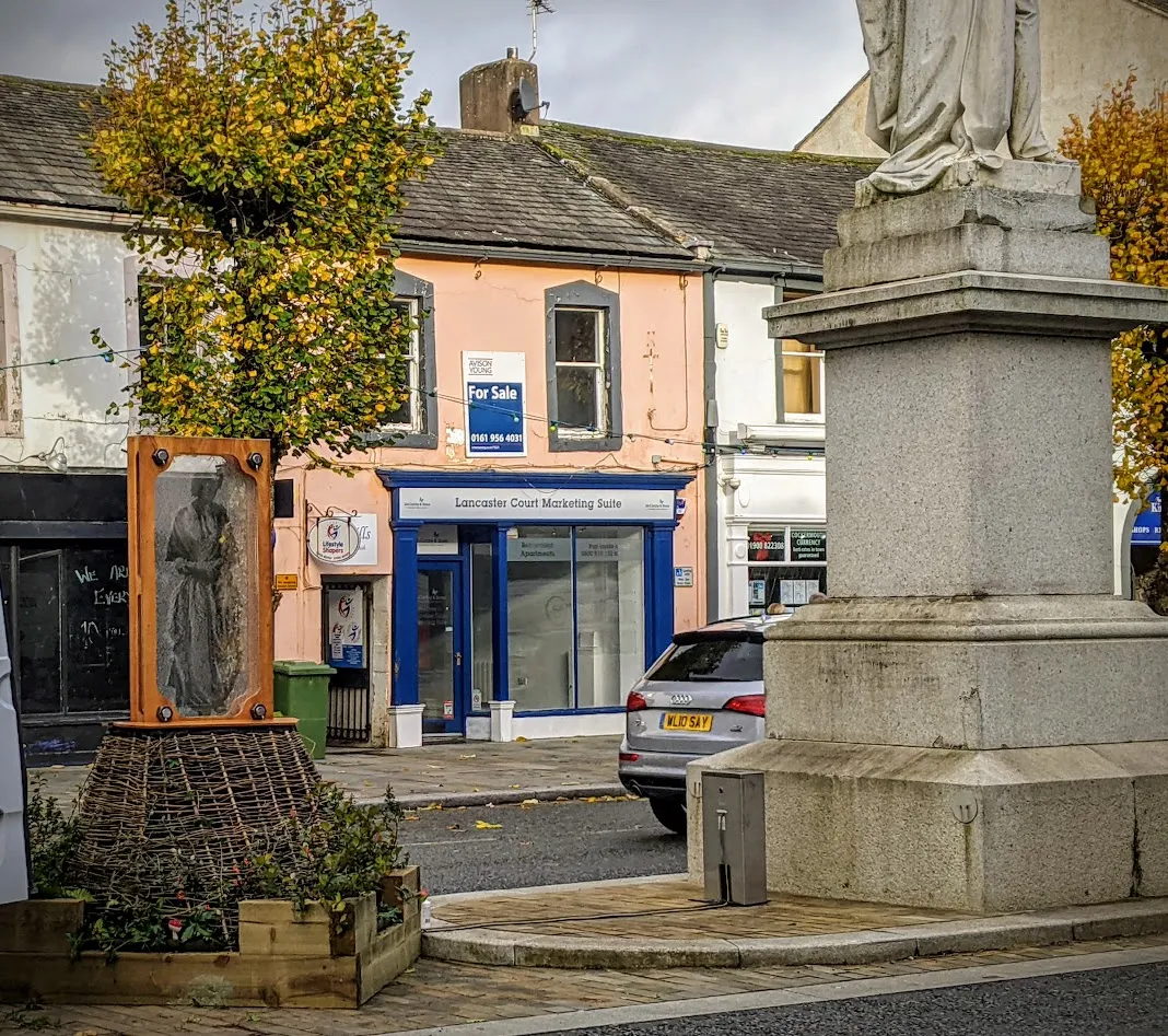 Sculpture with image of woman showing in transparent window.