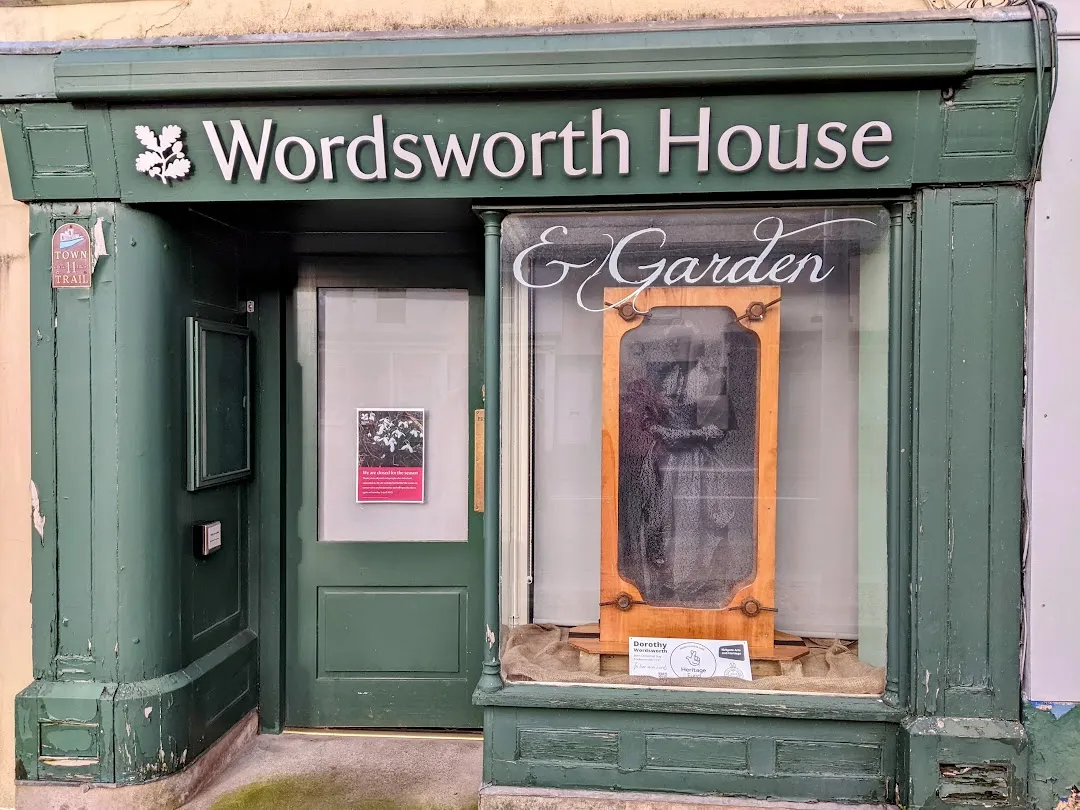 Wooden frame in window showing glowing image of Dorothy Wordsworth