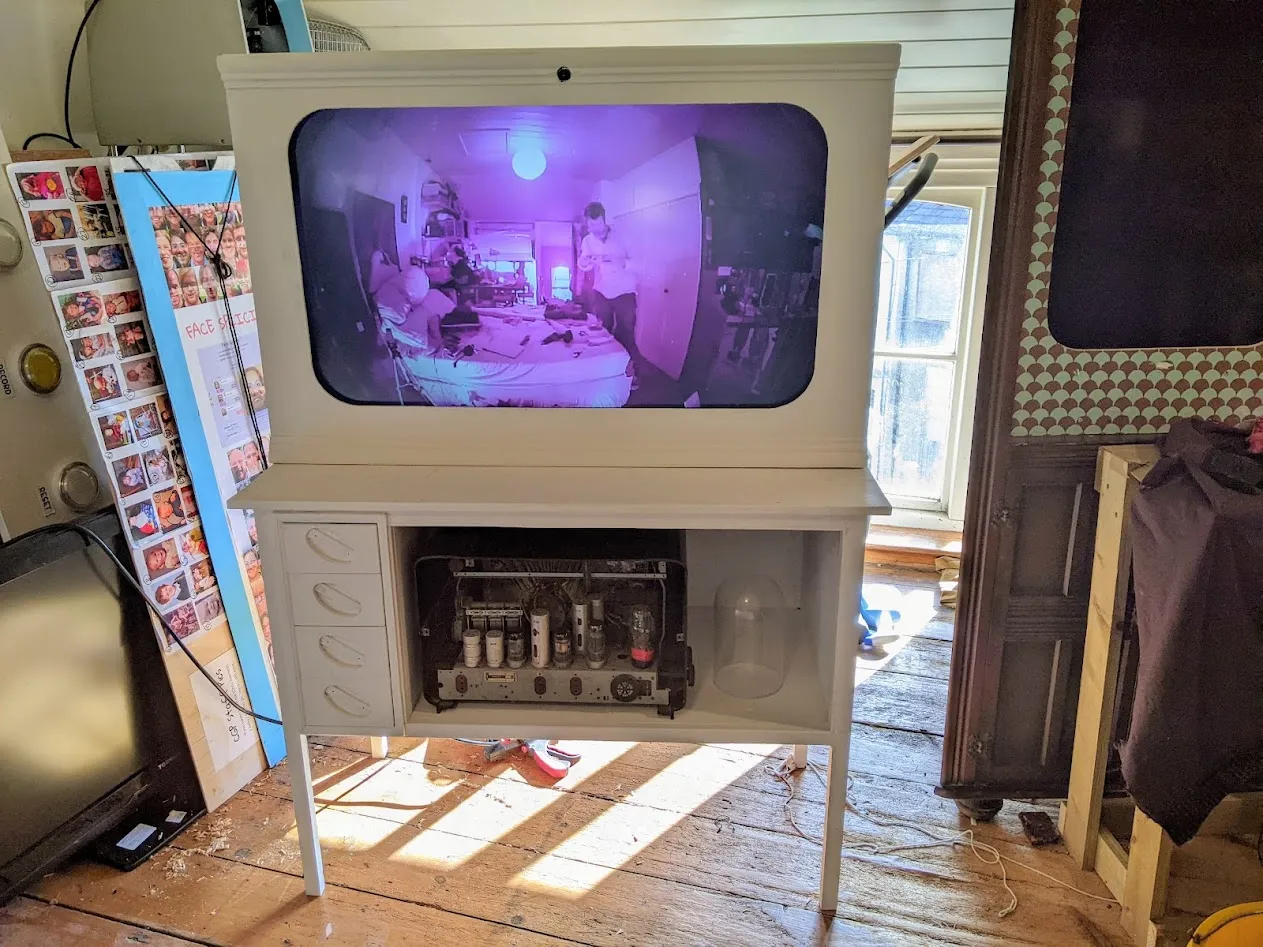 White cabinet containing tv screen