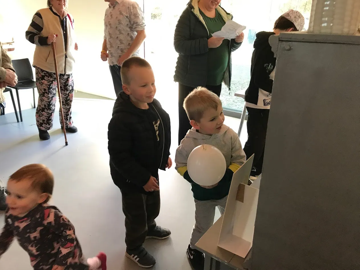 Crown children and adults at the back