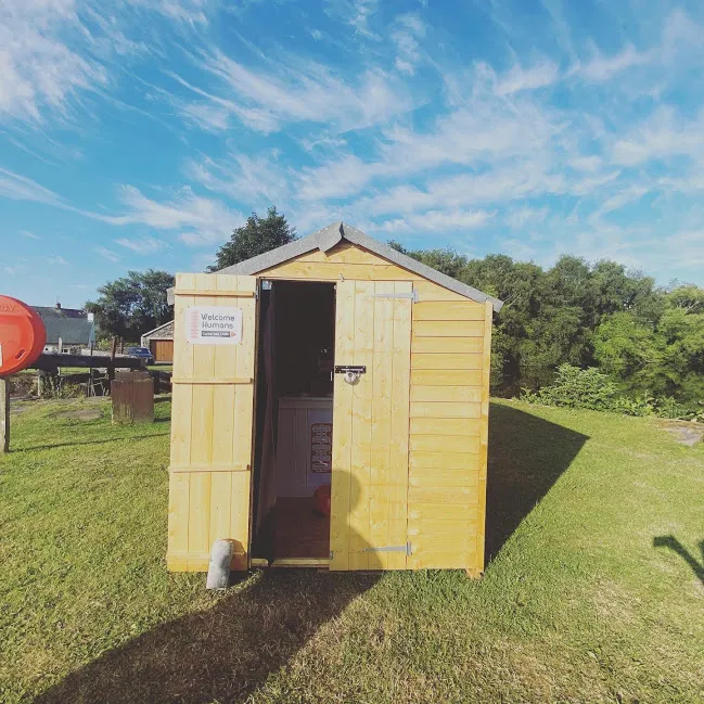 shed with open door and welcome sign