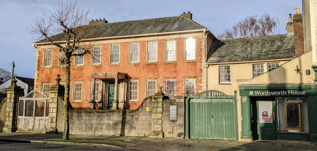 Large house with shop front next door