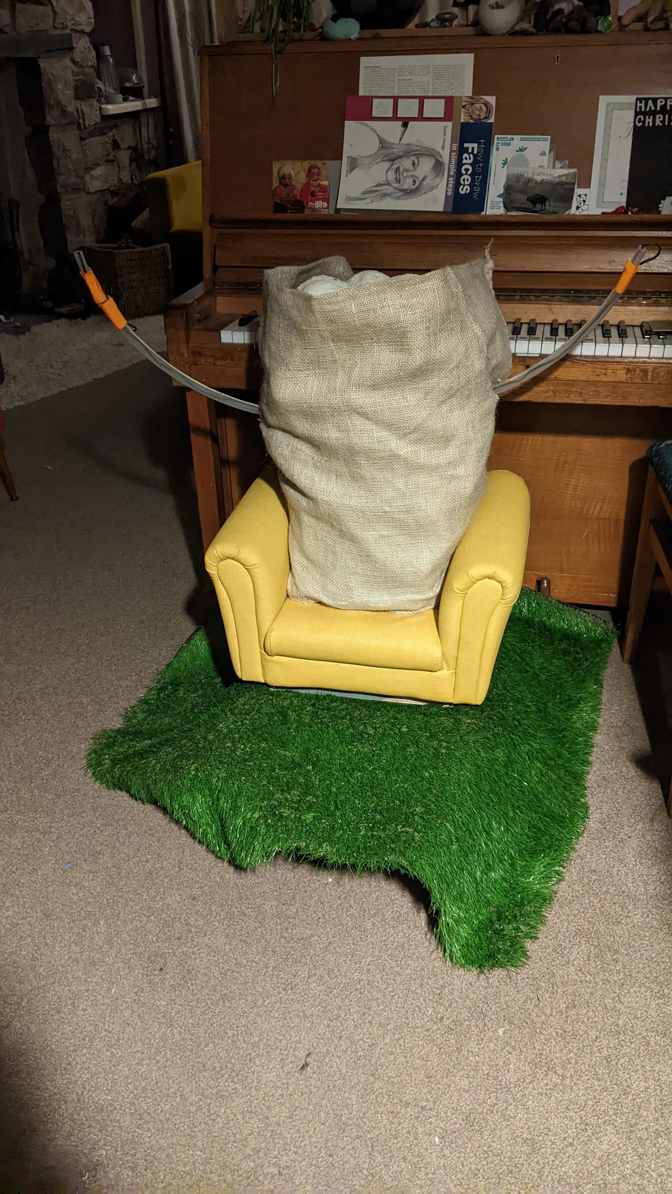 Coach Potato in front of a piano with arms up