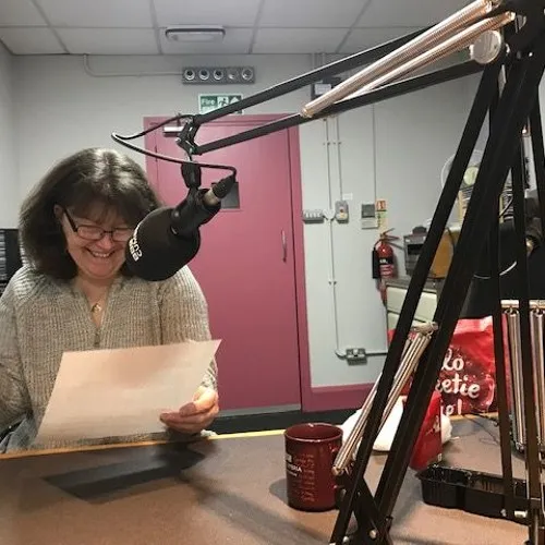 Woman reading into the microphone