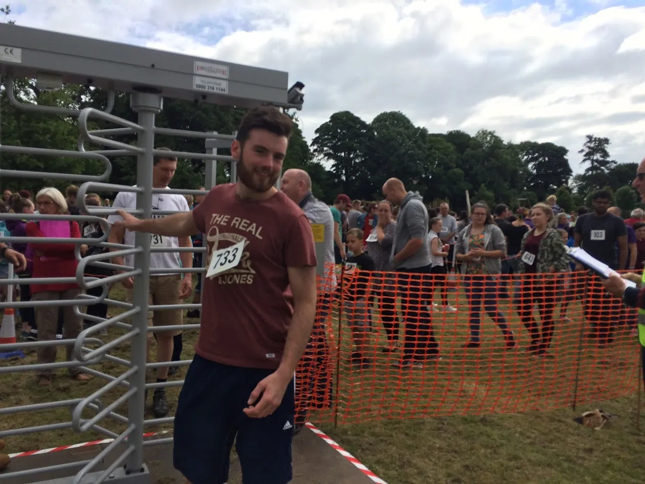 Man walking through turnstile with number on chest
