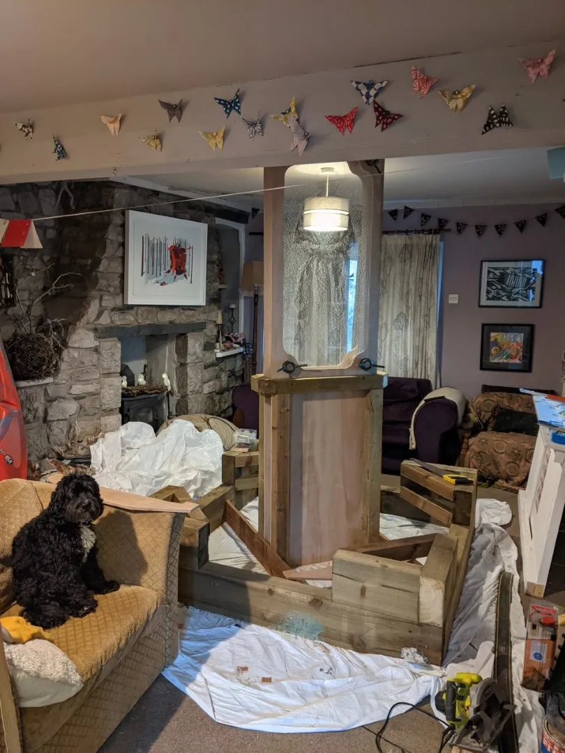 Dog on chair in front of wooden base and Perspex in frame