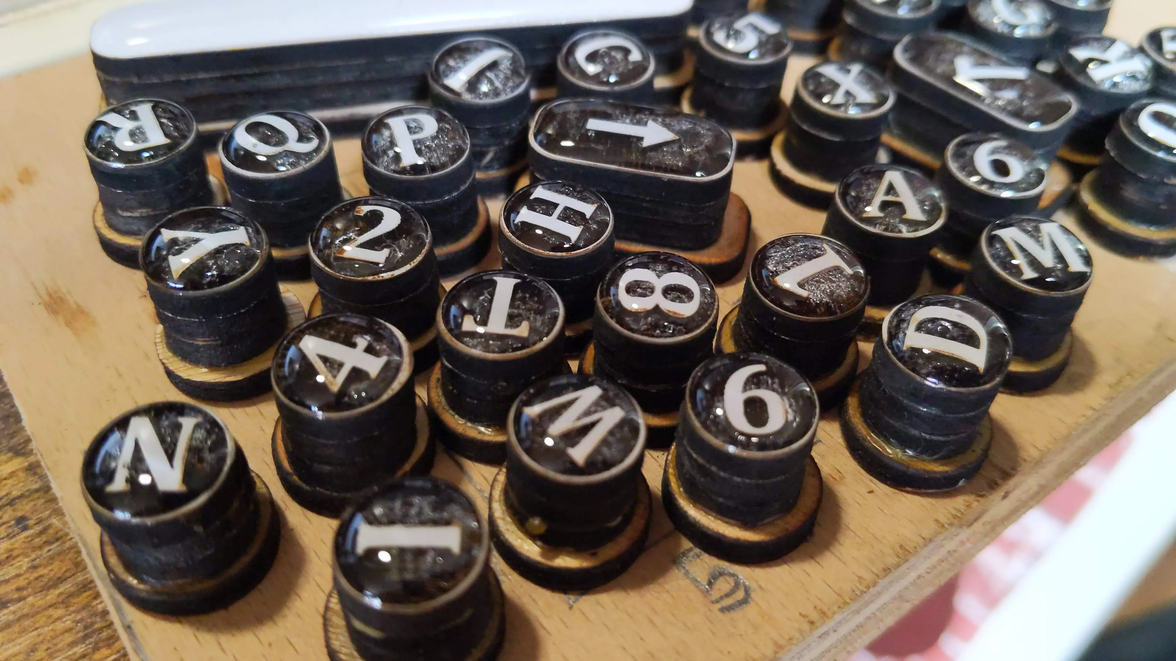 a jumble of typewritter keys on a board.
