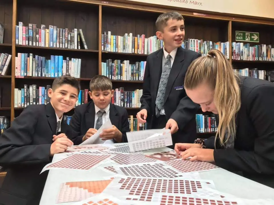 Four children peeling stickers.