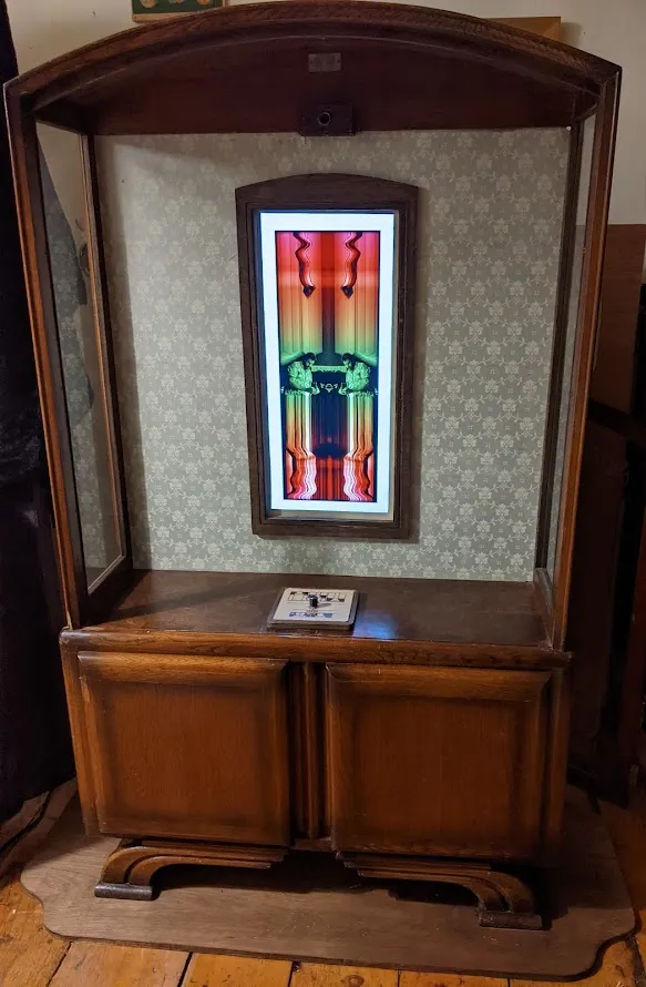 Cabinet screen enclosure with curvy wooden
base.