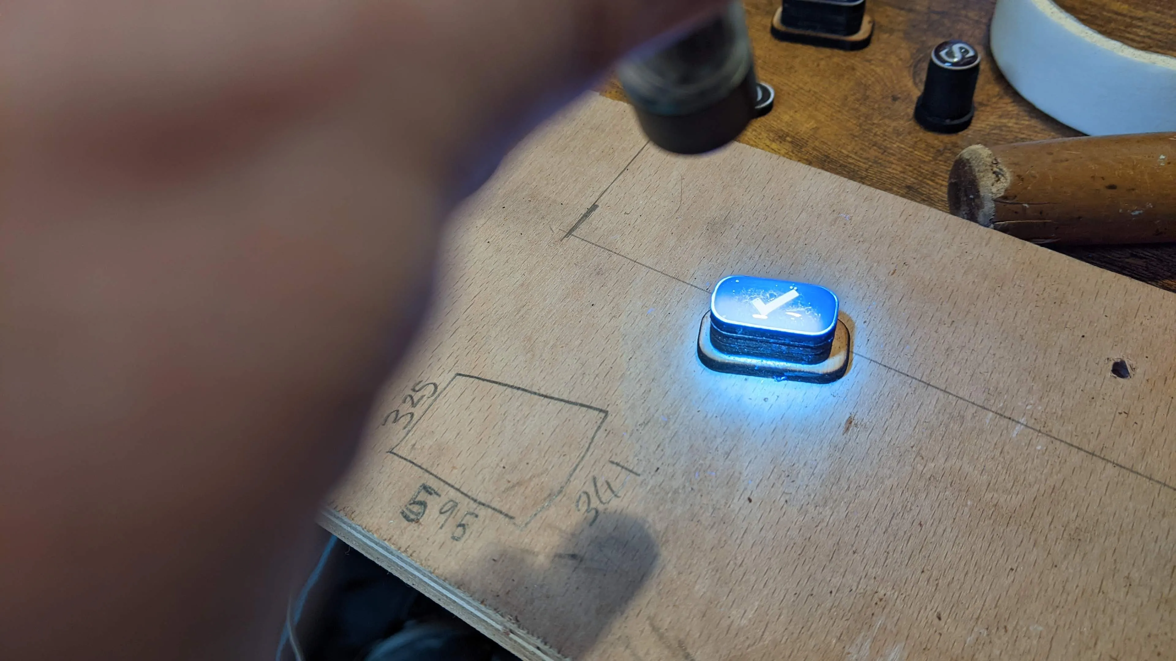 Blue light torch shining on a keyboard key.