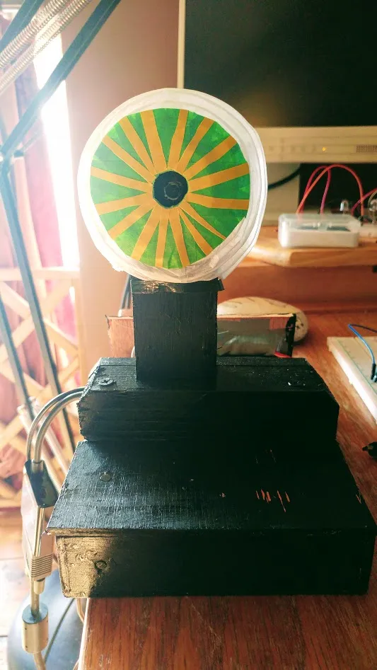 Paper eyeball on wooden box.
