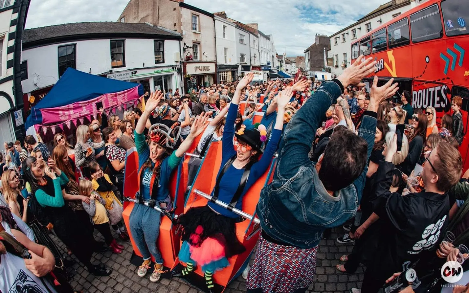 Huge crowd of people around people wearing cardboard rollercoaster outfits