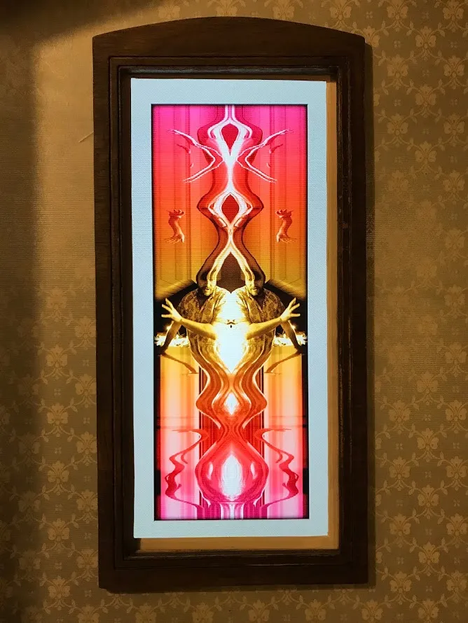 Image of man reflected and tinted from pink to yellow and back to pink
again