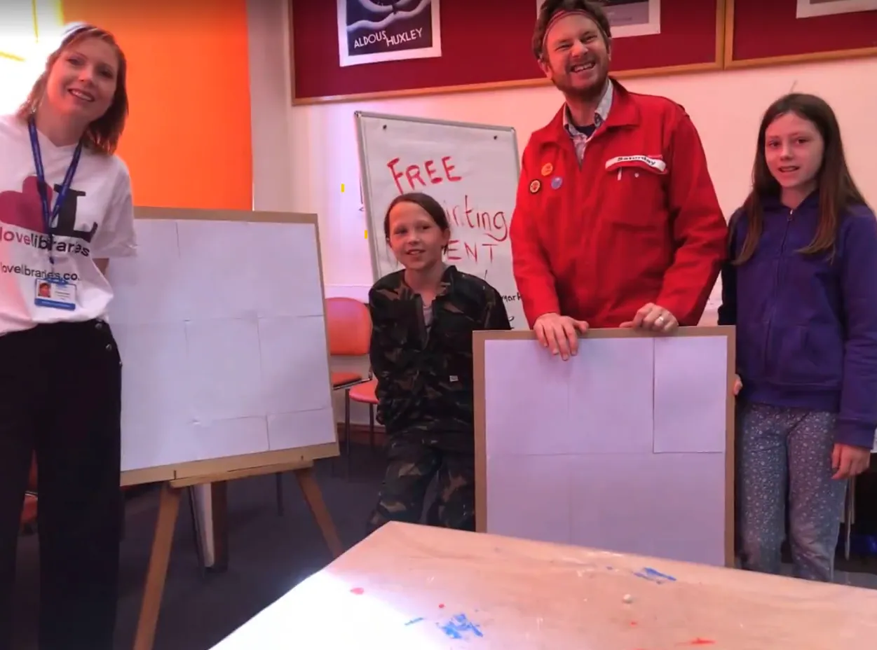 People standing in library with boards.
