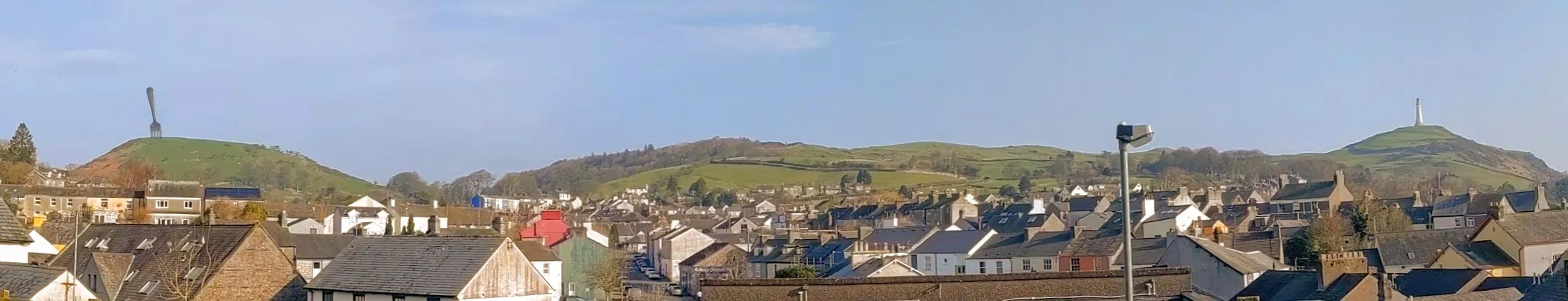 A drawing of a giant table fork stuck in a hill