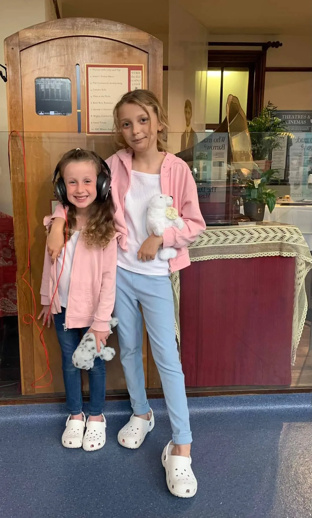 Two children standing in front of a gramophone