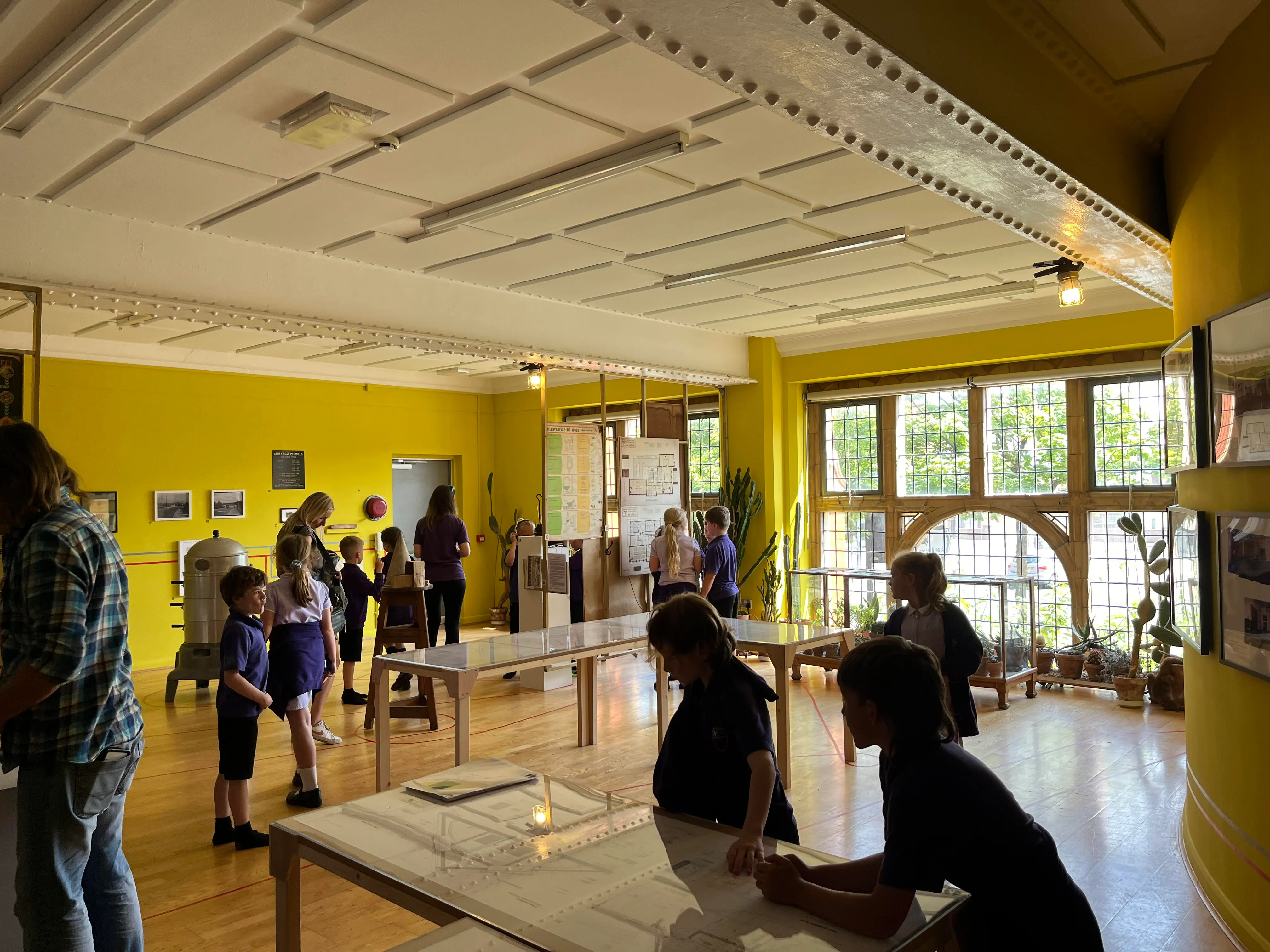 gallery space with school children spread throughout.