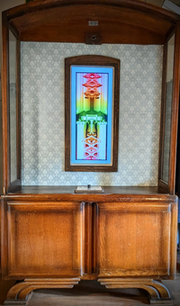 Screen within a display cabinet showing a colourful smear