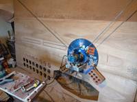 Machine hanging on sheet of plywood