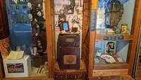 Large old fashioned radio with tray on top containing a picture frame.