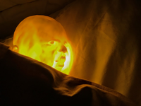 Glowing baby head on pillow.