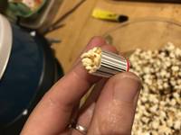 hand holding tiny popcorn container